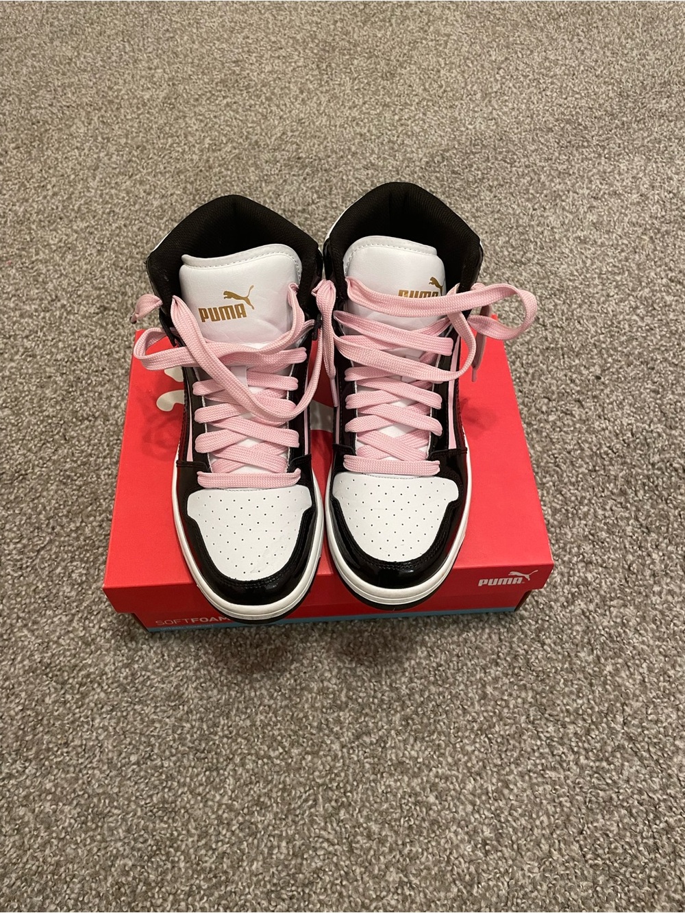 Pink and black high top puma
